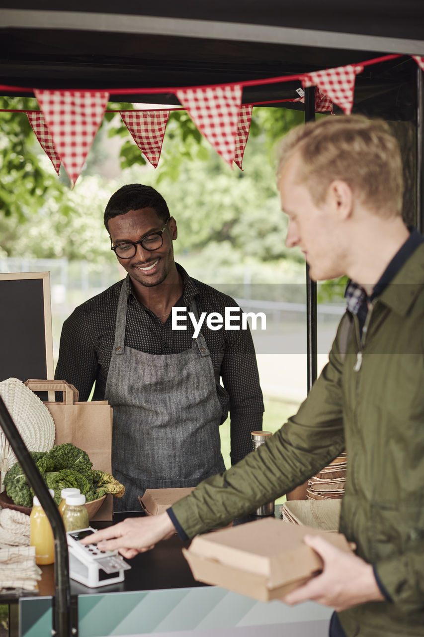 Clients buying food at food stall