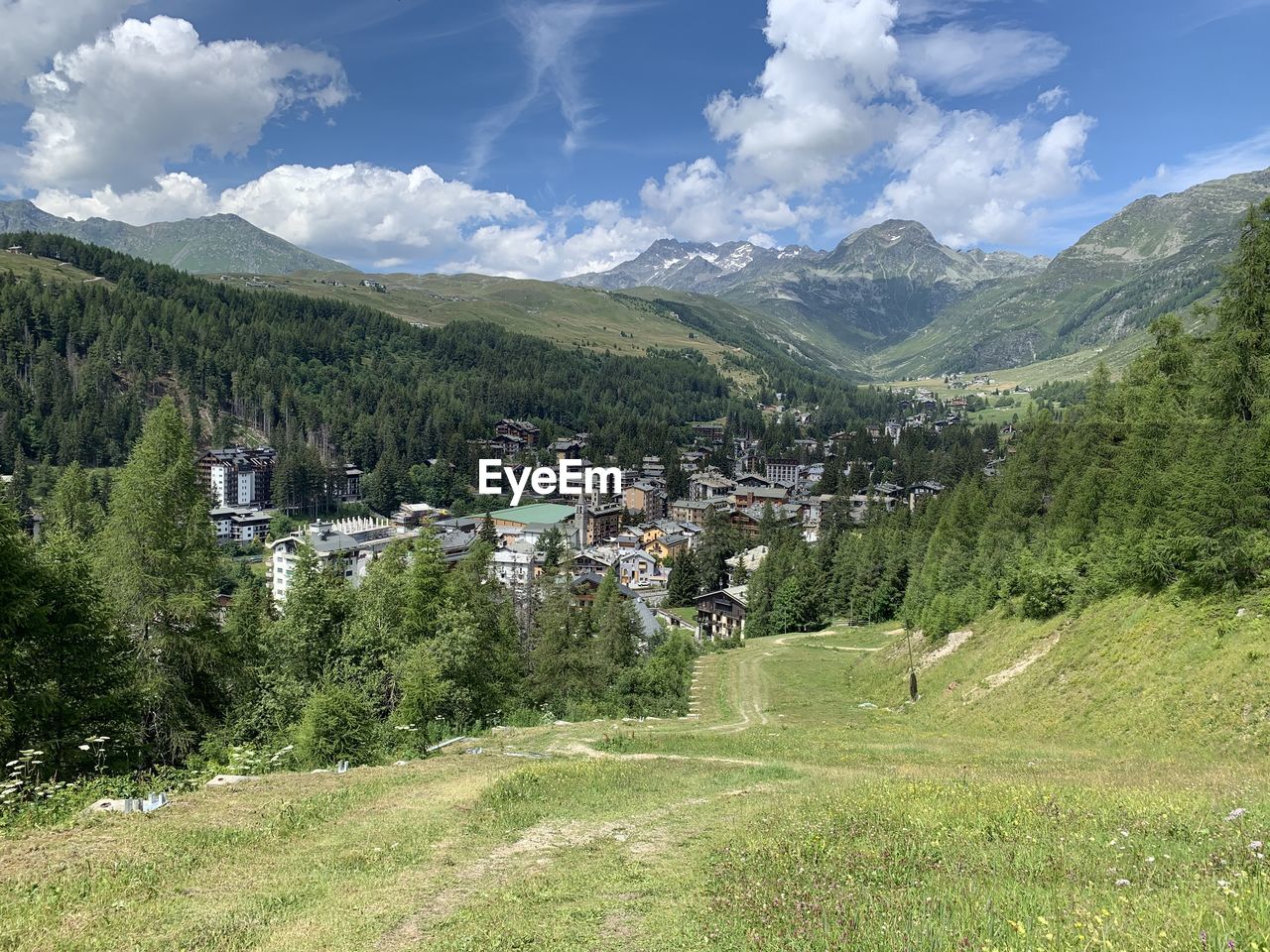 Scenic view of green landscape and mountains against sky