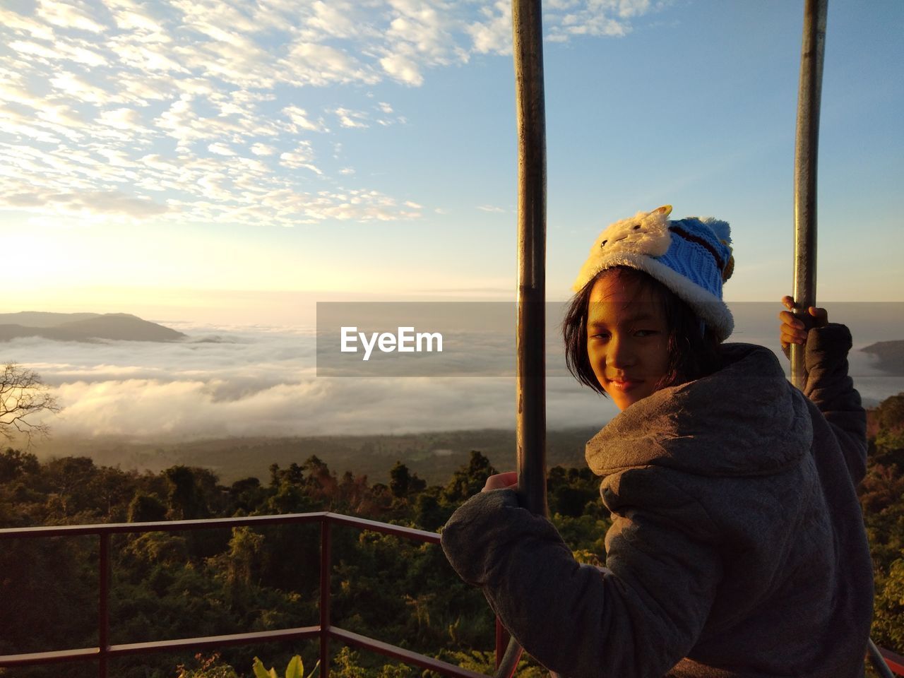 Portrait of smiling girl wearing warm clothing at observation point
