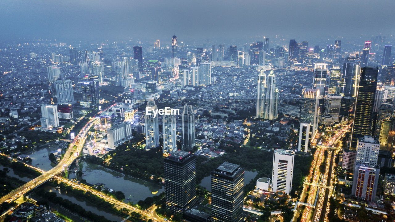 High angle view of modern buildings in city against sky