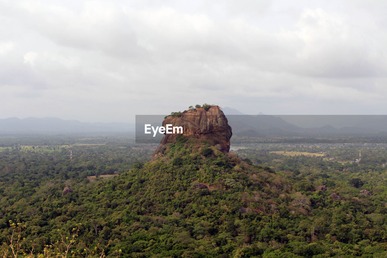 ROCK FORMATION ON LANDSCAPE AGAINST SKY