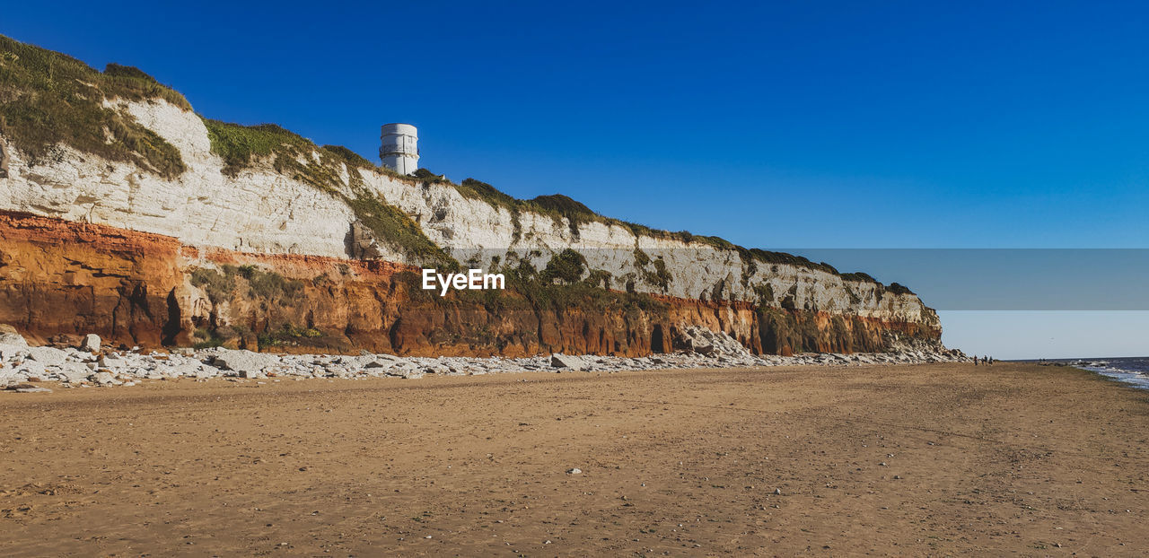 PANORAMIC SHOT OF BEACH AGAINST CLEAR BLUE SKY