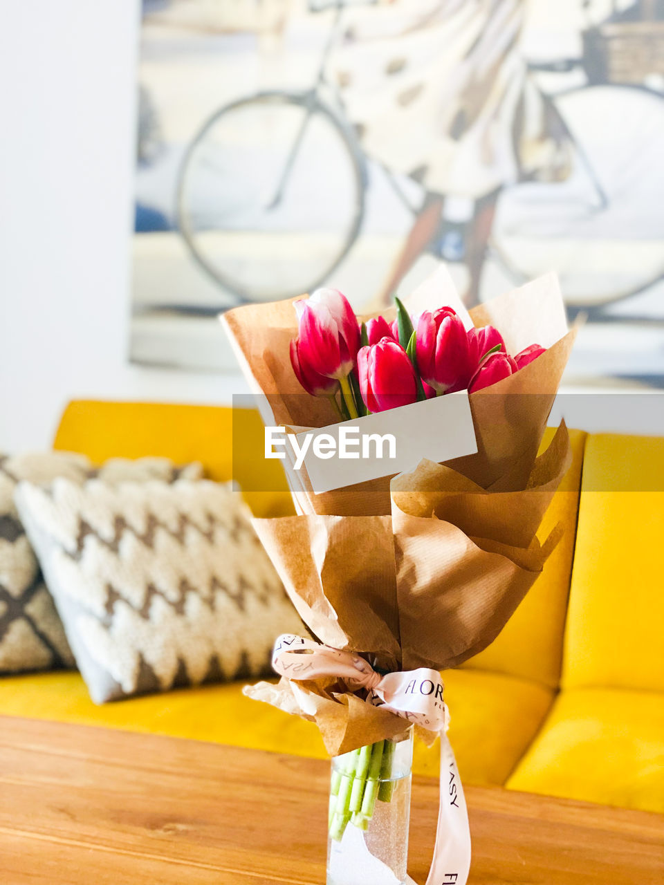 Bouquet of beautiful pink tulips in transparent vase isolated .