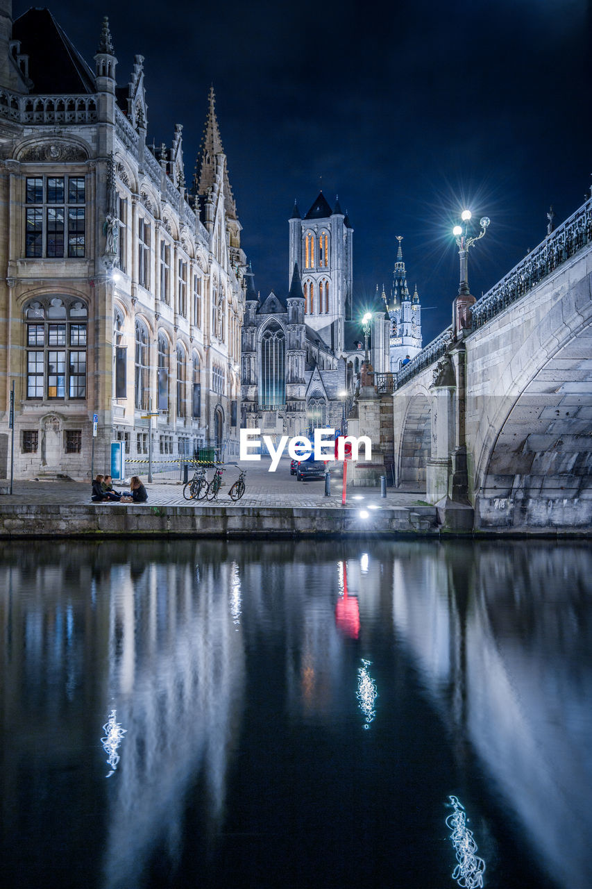 Reflection of buildings in canal at night