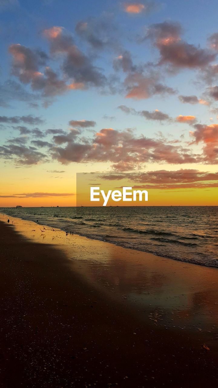 SCENIC VIEW OF BEACH DURING SUNSET