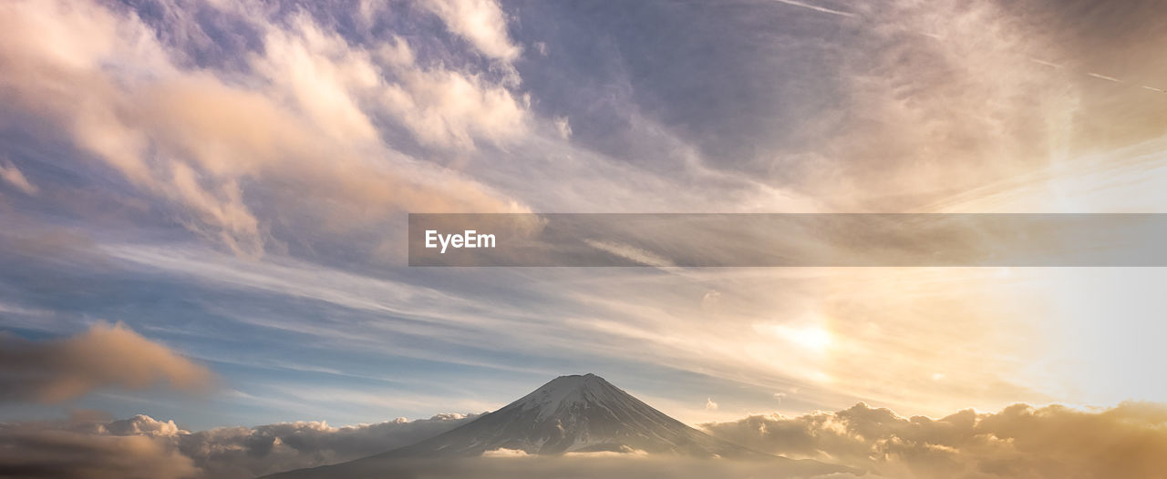 Scenic view of snowcapped mountains against sky during sunset