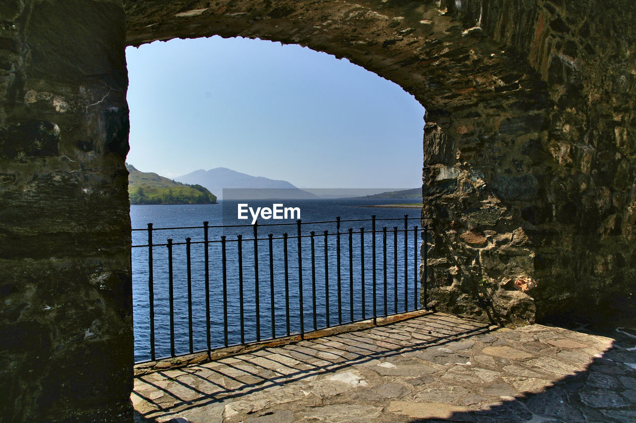 SCENIC VIEW OF SEA SEEN THROUGH ARCH
