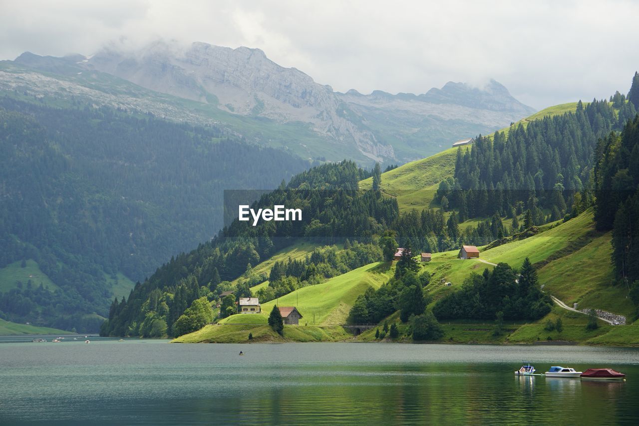 Scenic view of lake and mountains against sky