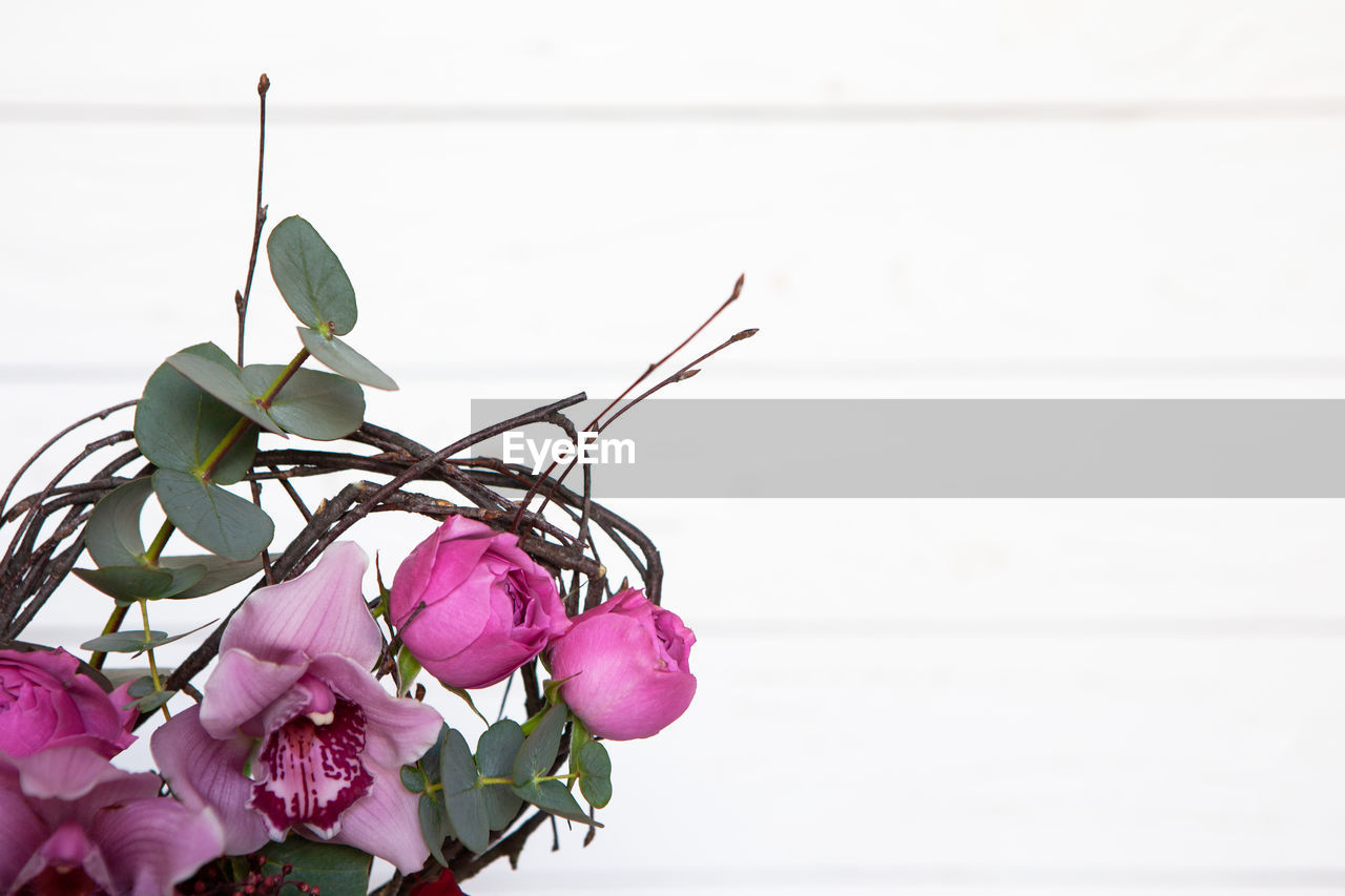 Creative flower bouquet on white wooden background. focus on flowers, background is blurred. mockup