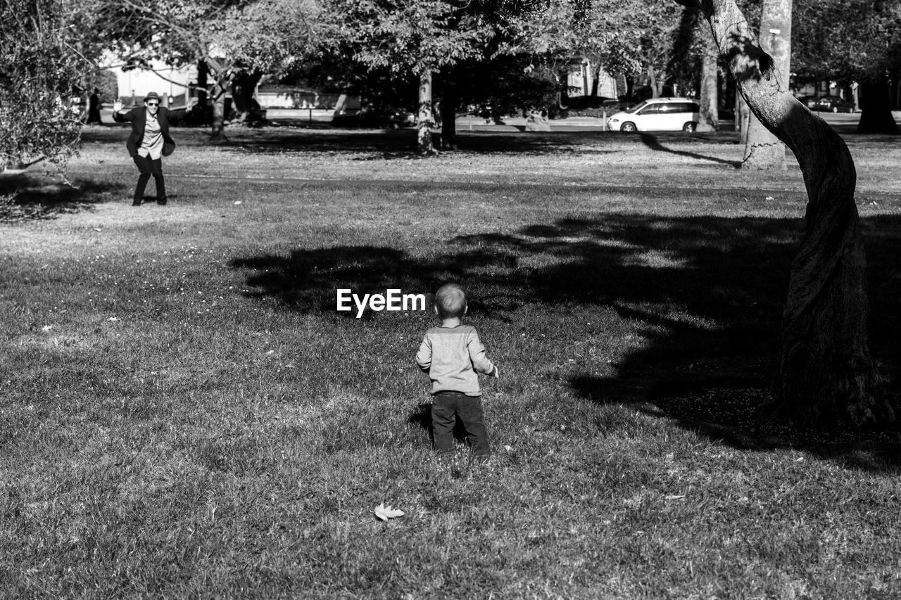 FULL LENGTH OF BOY STANDING ON PARK