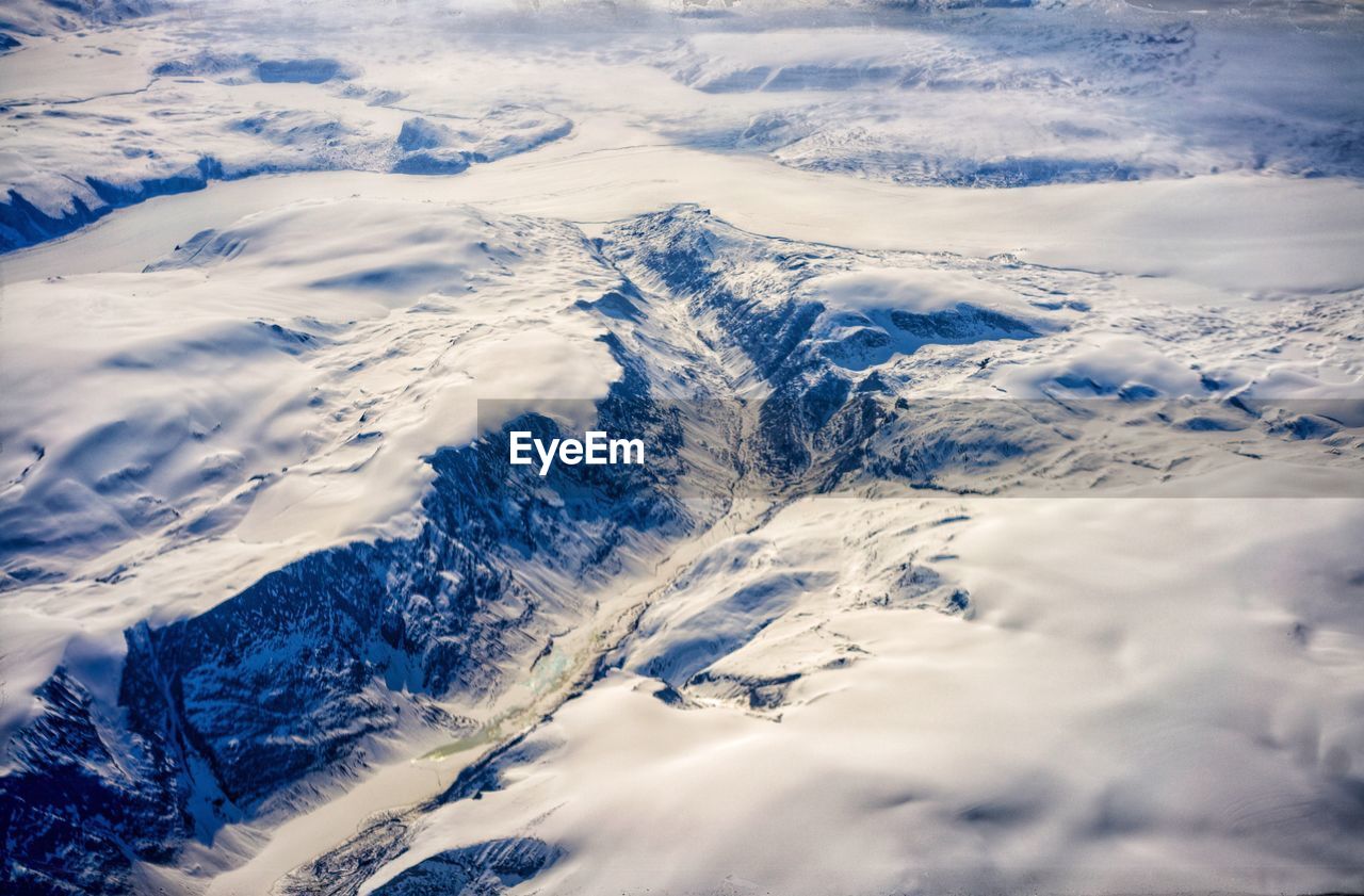 Aerial view of snowcapped mountains against sky