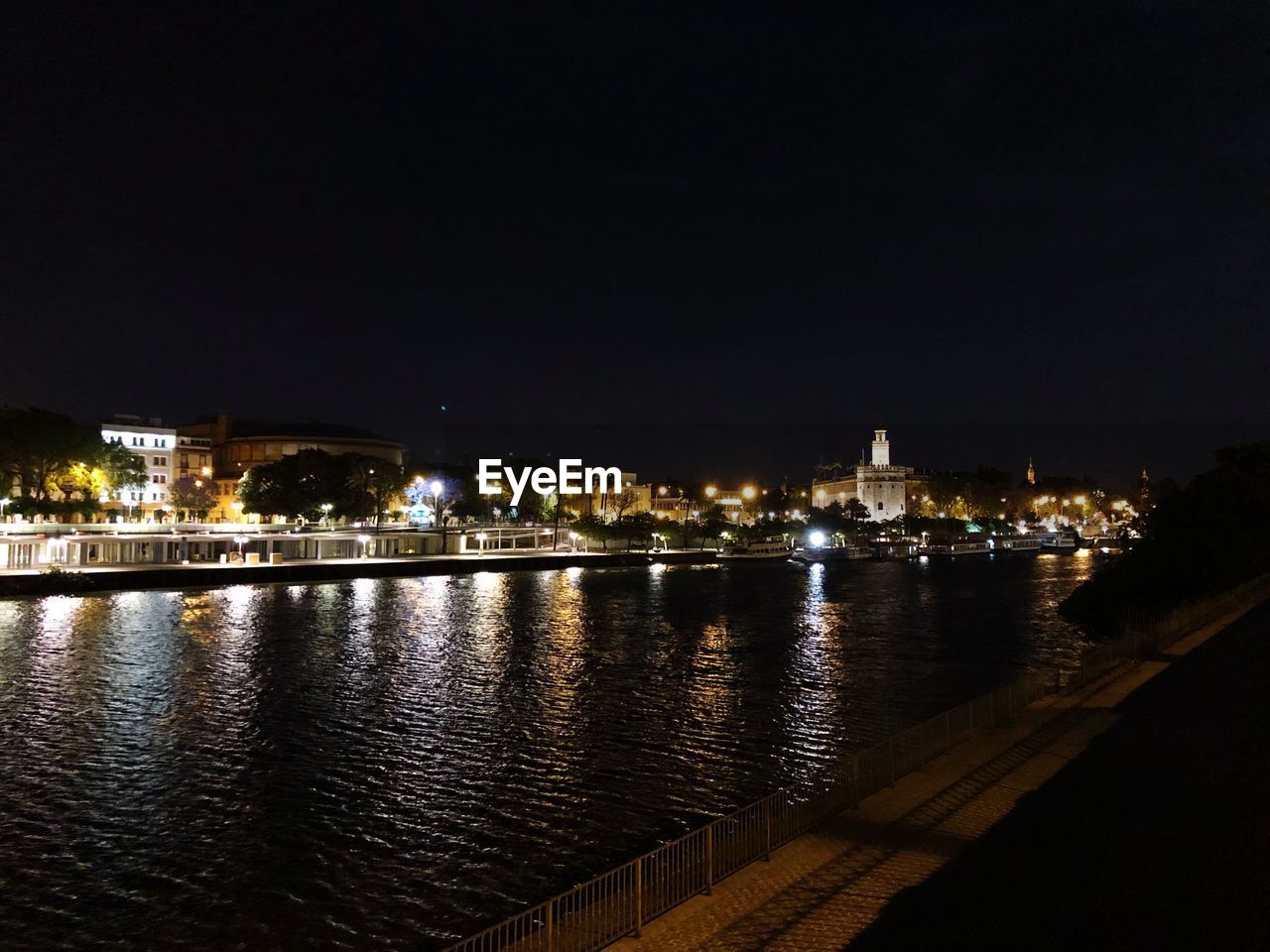 ILLUMINATED BUILDINGS AT WATERFRONT