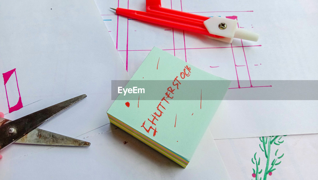 indoors, art, paper, no people, scissors, pencil, airplane, creativity, studio shot, text, still life, high angle view, wing, aircraft, pen