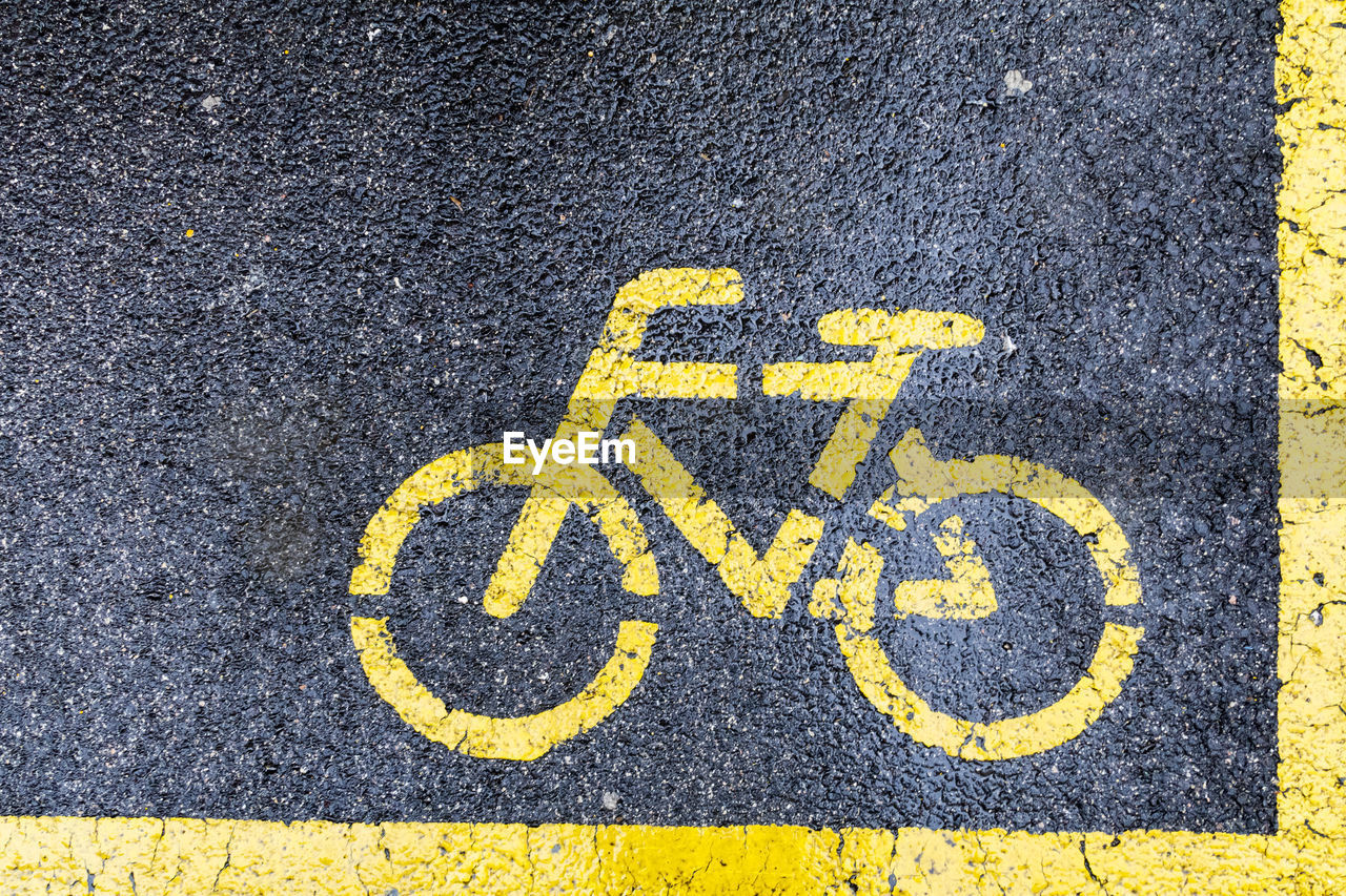 High angle view of yellow sign on road