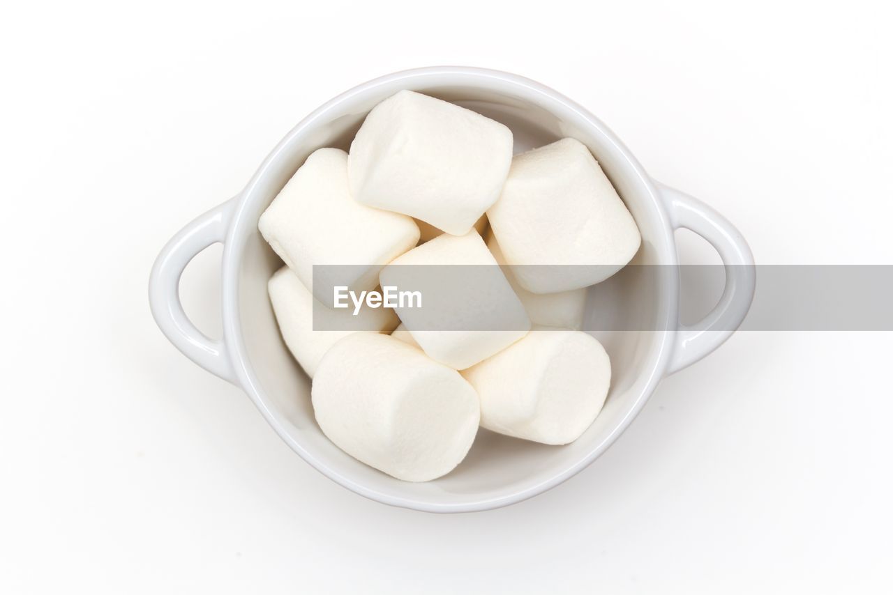 High angle view of marshmallow in bowl against white background