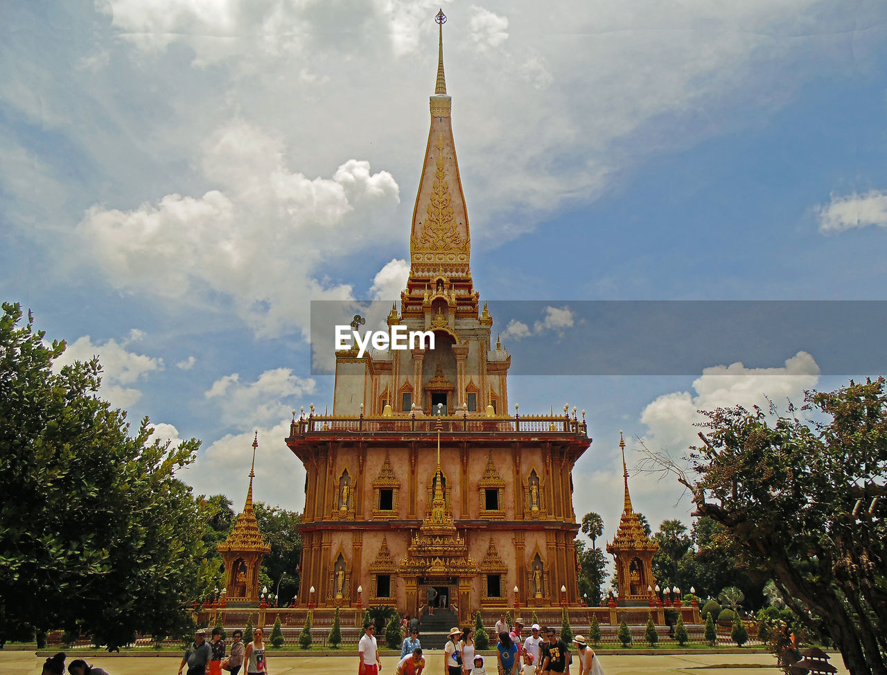 TOURISTS IN FRONT OF CHURCH AGAINST SKY