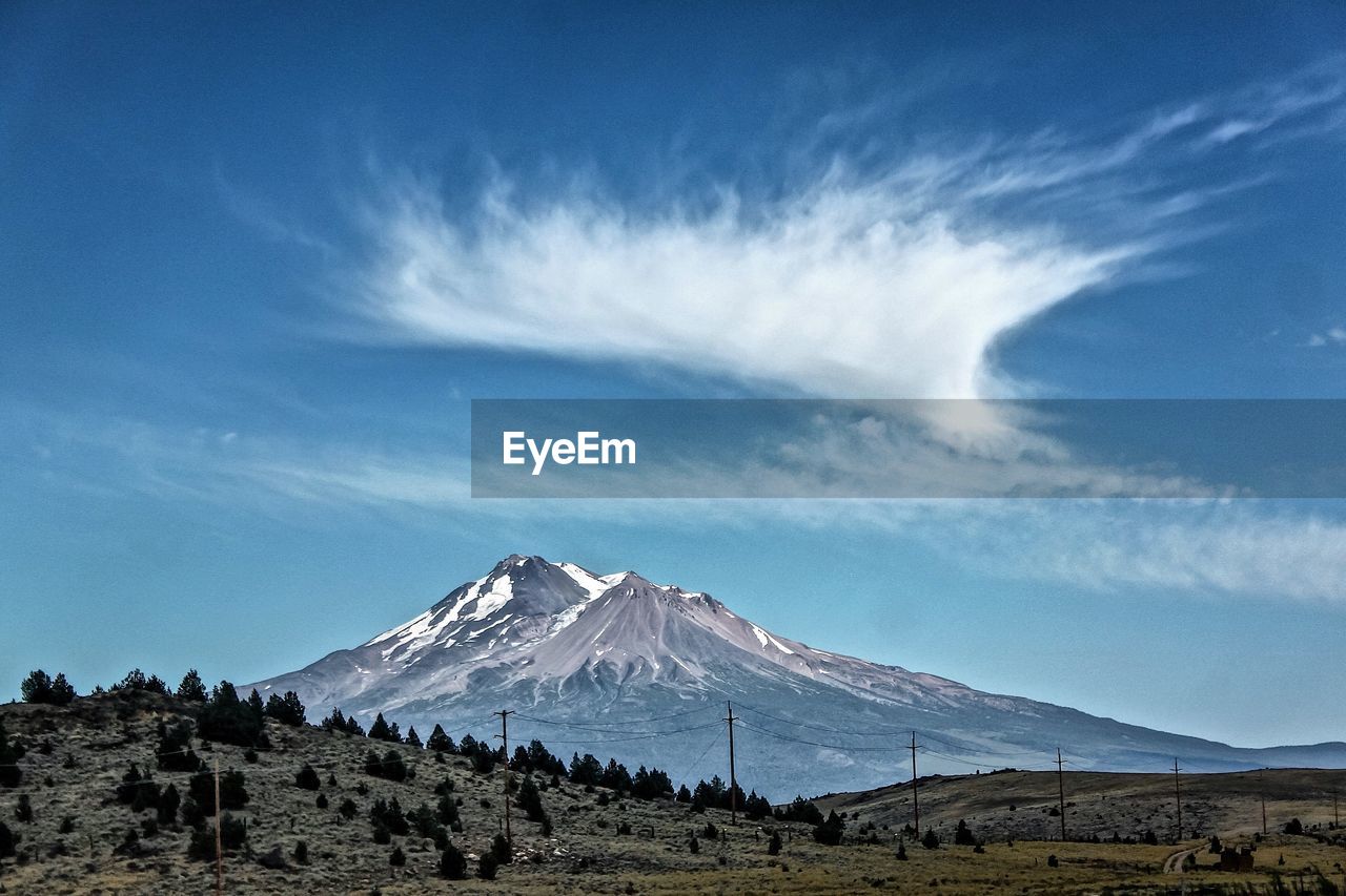 View of mountain range against blue sky