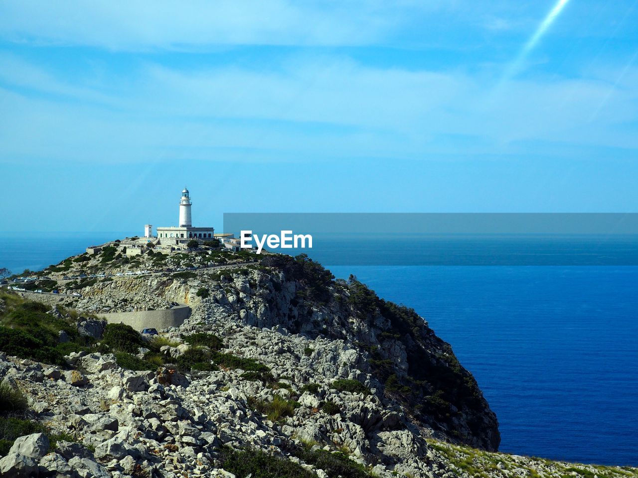 Cap de formentor lighthouse on cliff by sea