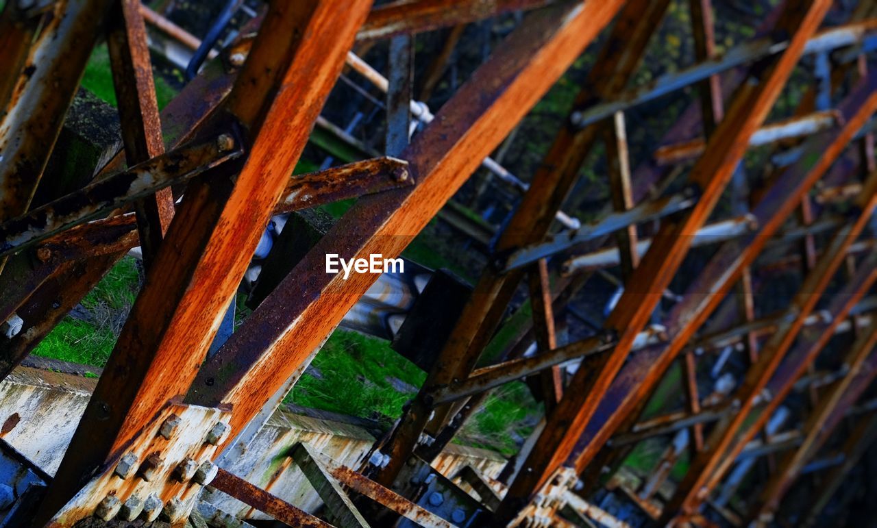 Tilt image of rusty metal structure on field