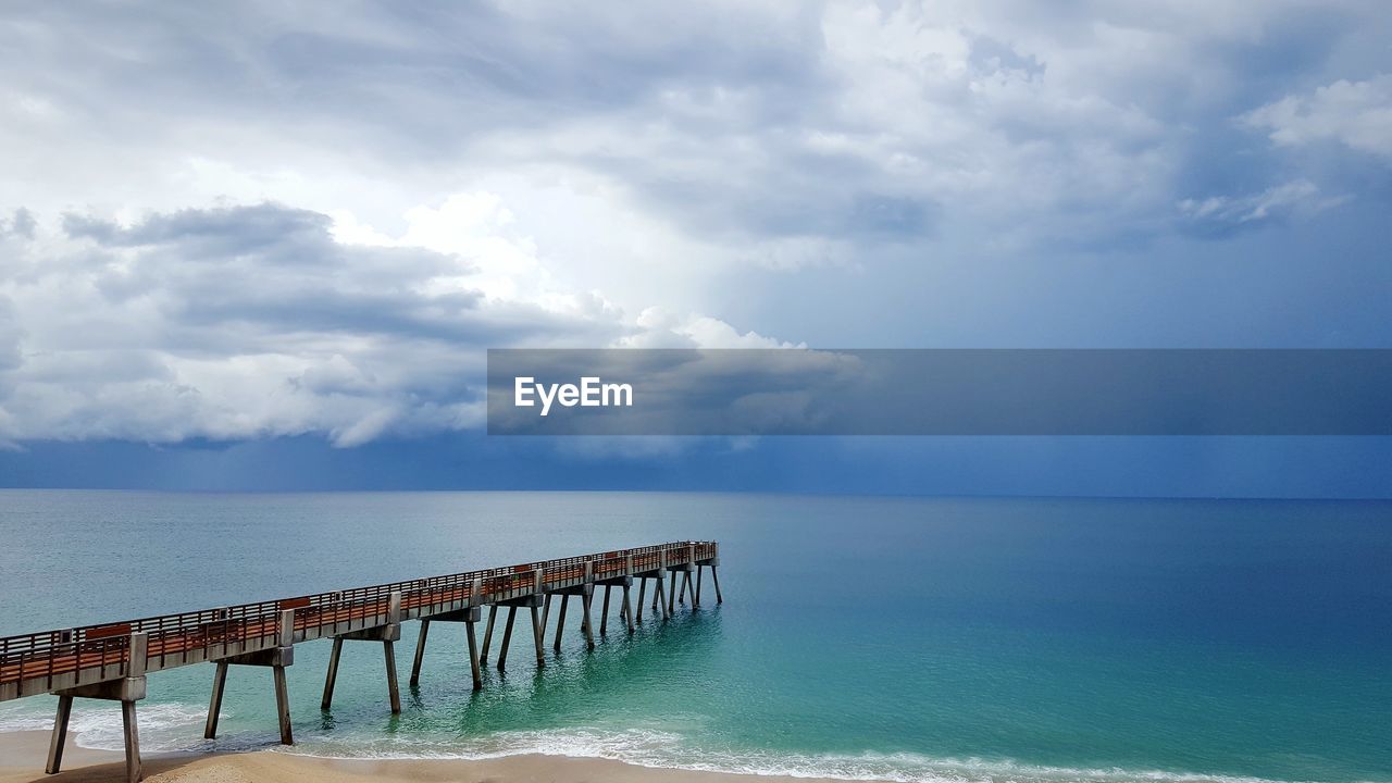 Pier over sea against sky