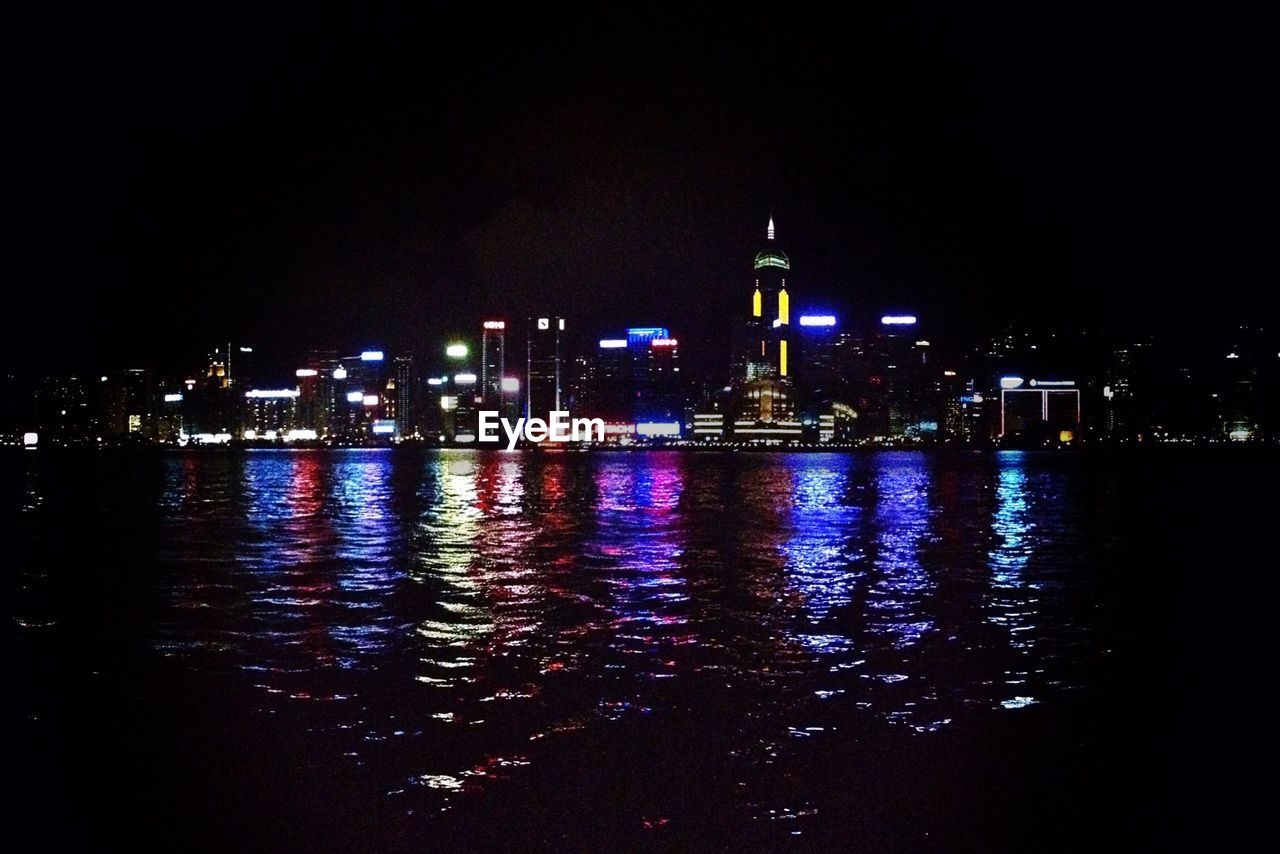 River with illuminated buildings in distance