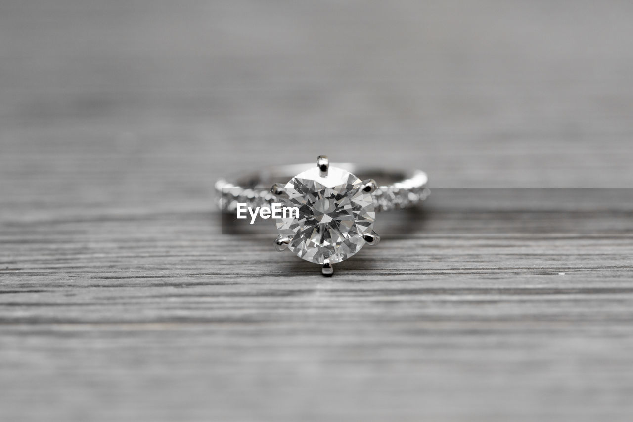 Close-up of diamond ring on table