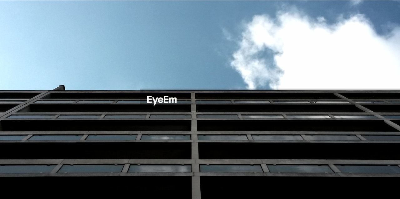 Low angle view of building against cloudy sky