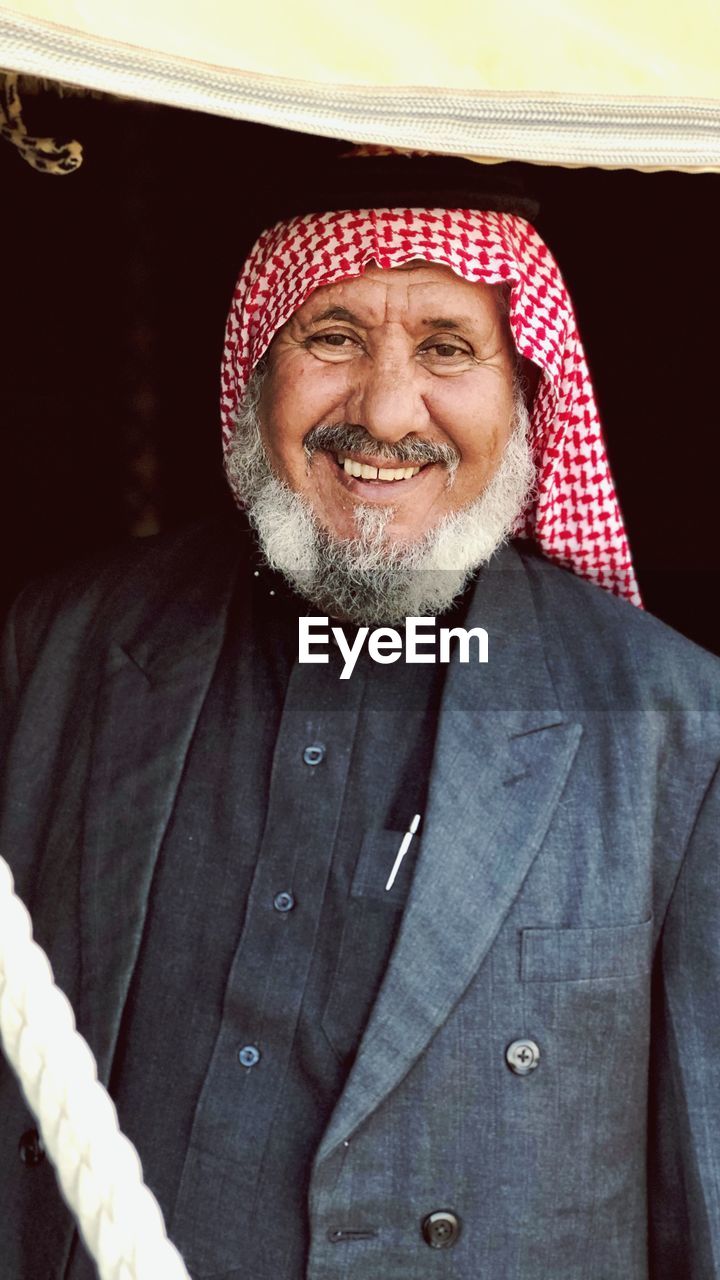 Portrait of smiling bearded senior man wearing suit