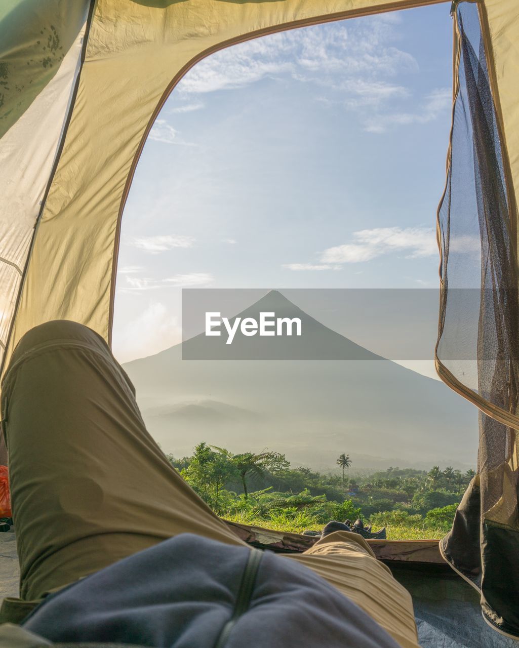 Low section of tent view of volcano against sky