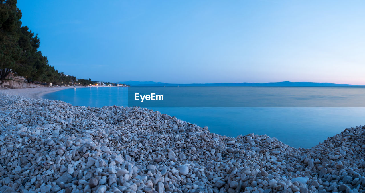 Scenic view of sea against clear blue sky