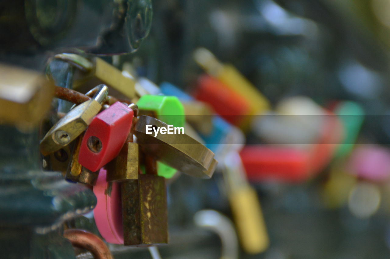 Close-up of padlocks hanging on wooden post