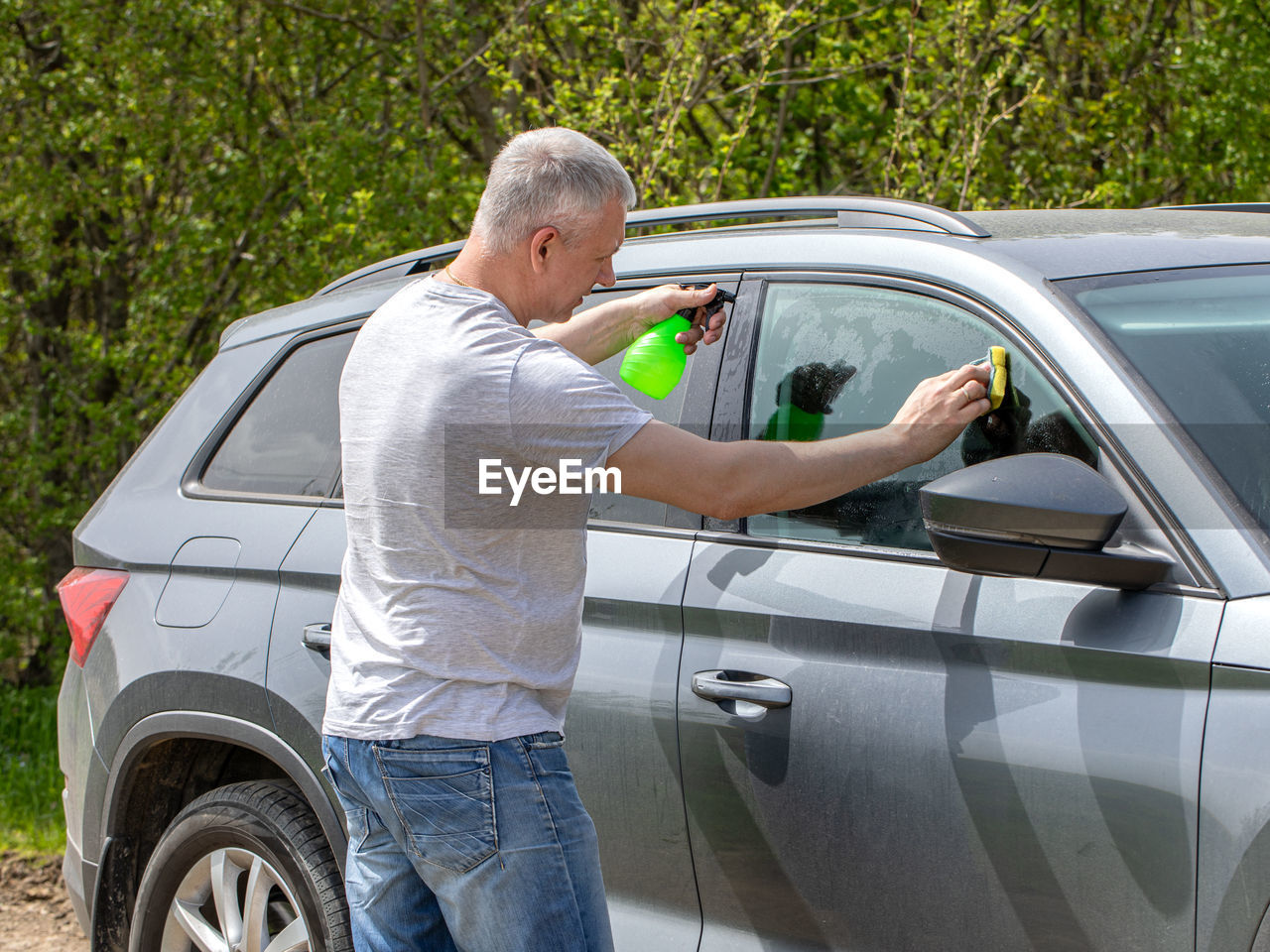 Young man washing the car with a sponge high quality photo