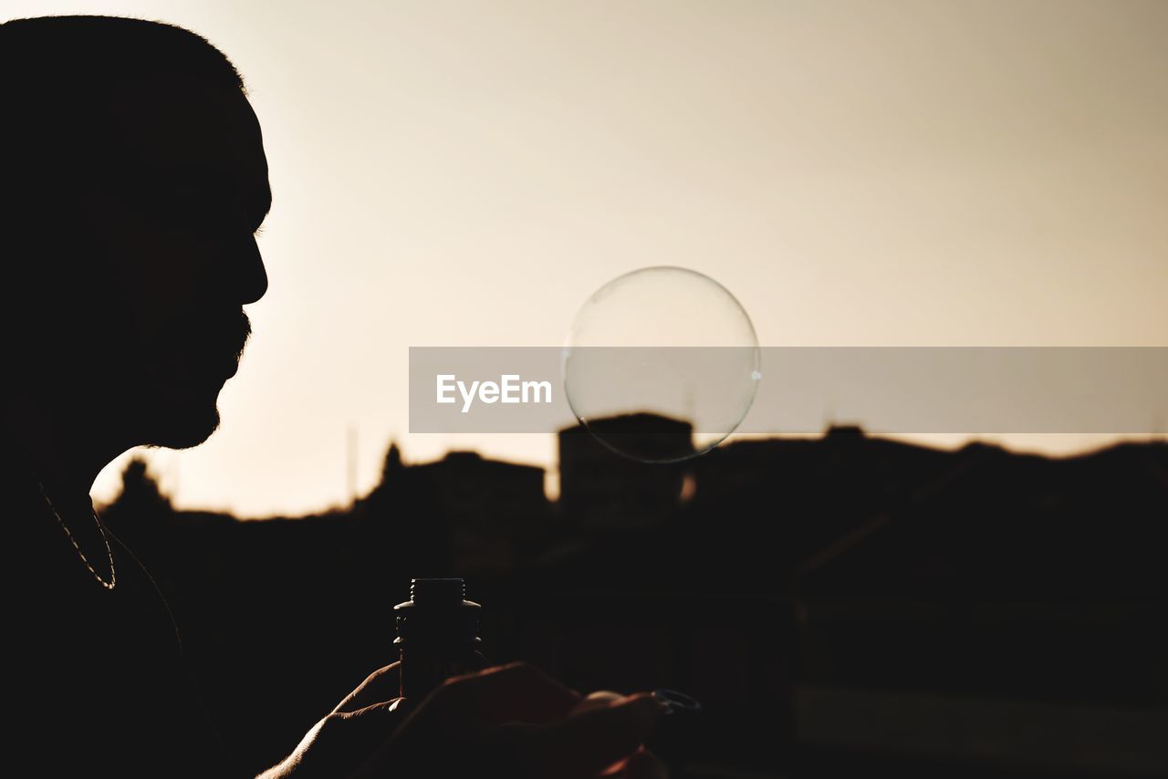 PORTRAIT OF SILHOUETTE MAN HOLDING BEER GLASS AGAINST SKY