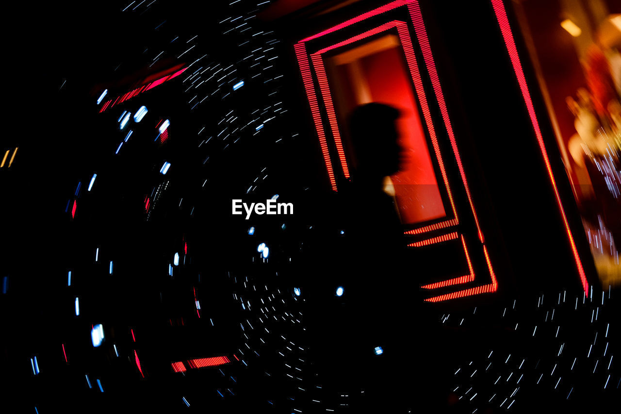 night, illuminated, font, no people, motion, indoors, red, dark, low angle view, lighting equipment