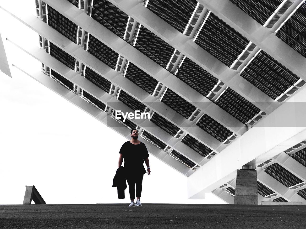 Man walking against modern building