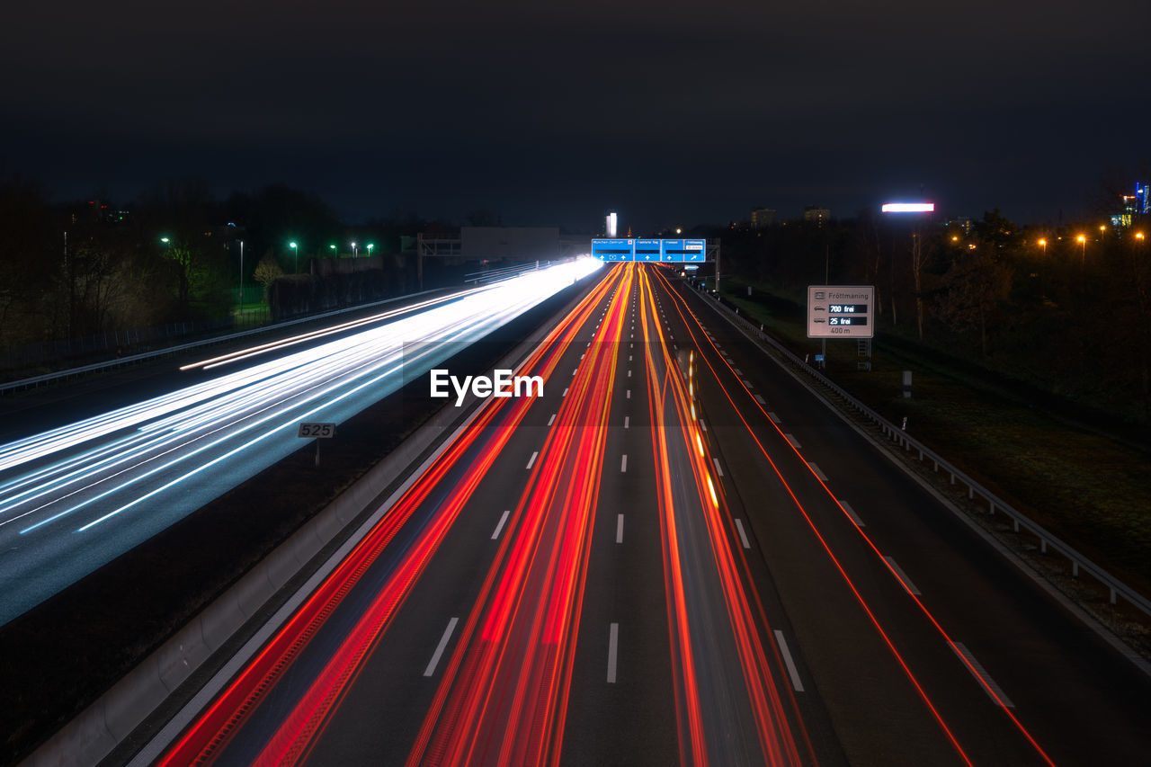 High angle view of light trails on highway at night