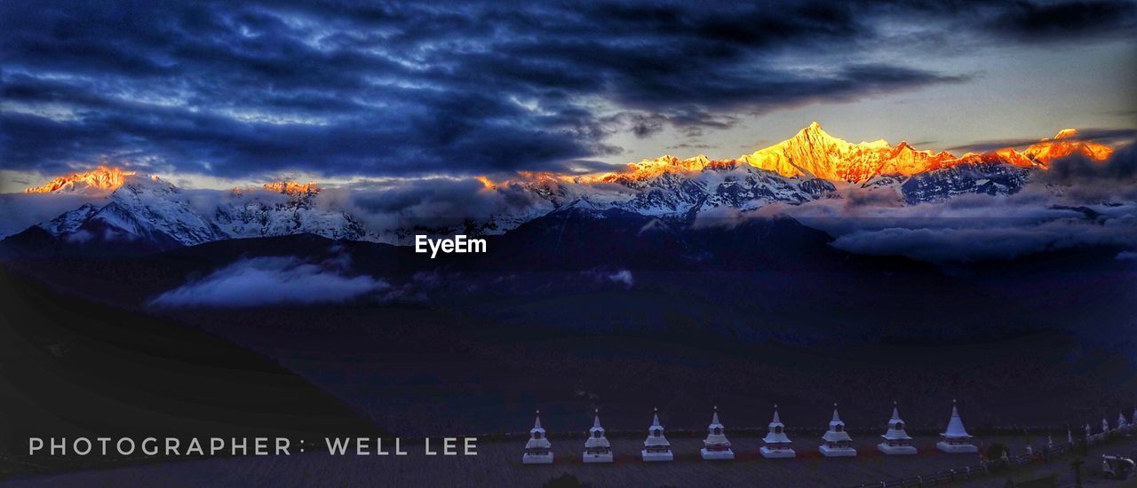 PANORAMIC VIEW OF SNOWCAPPED MOUNTAIN AGAINST CLOUDY SKY