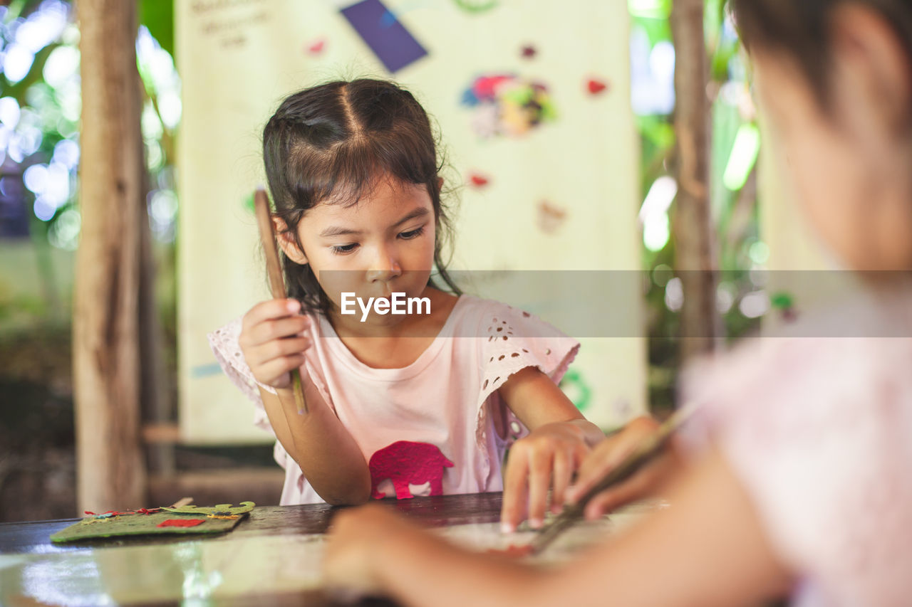 Close-up of cute girl making artwork at workshop