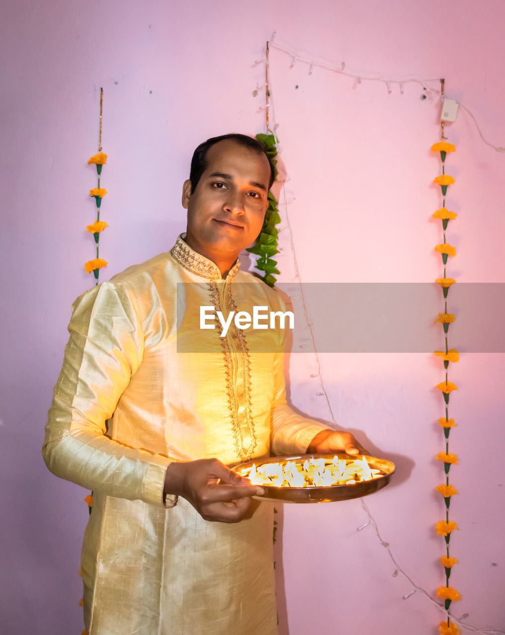 Man holding lighted candles many kept in plat for diwali cultural celebration lightnings