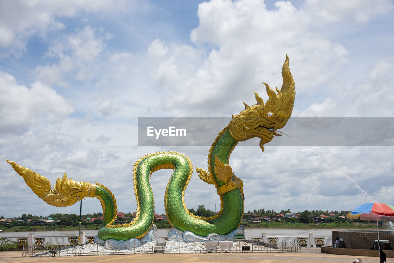 LOW ANGLE VIEW OF A STATUE AGAINST BLUE SKY