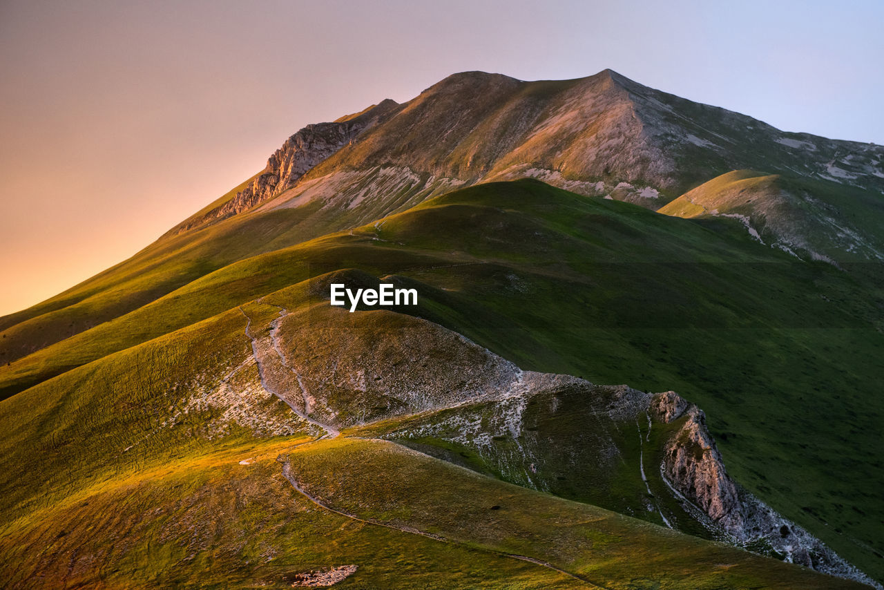 Scenic view of mountains against clear sky during sunset