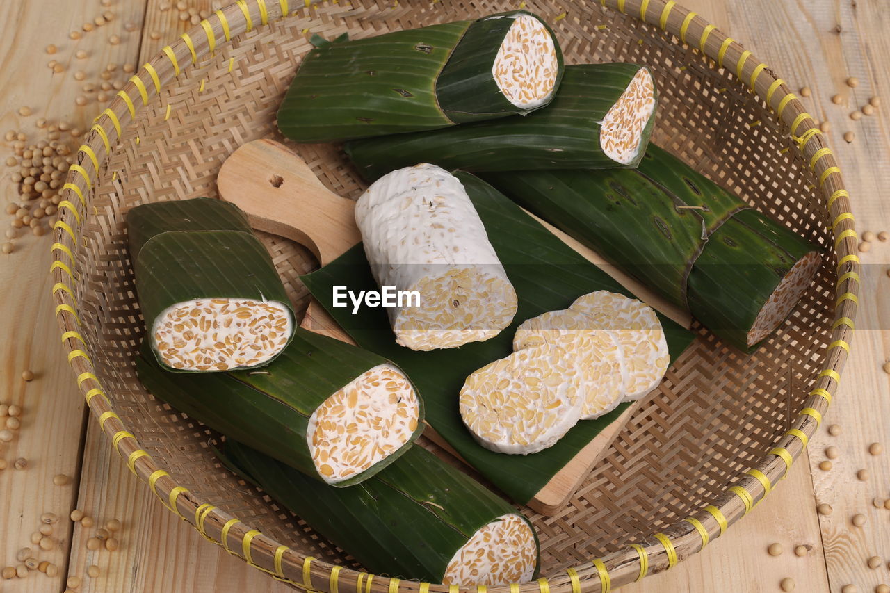 Close-up of food wrapped in banana leaves on wooden table