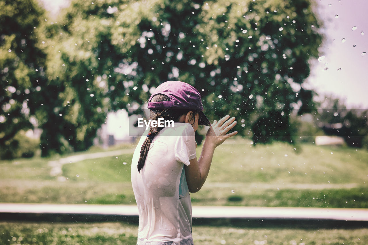 Girl getting splashed with water