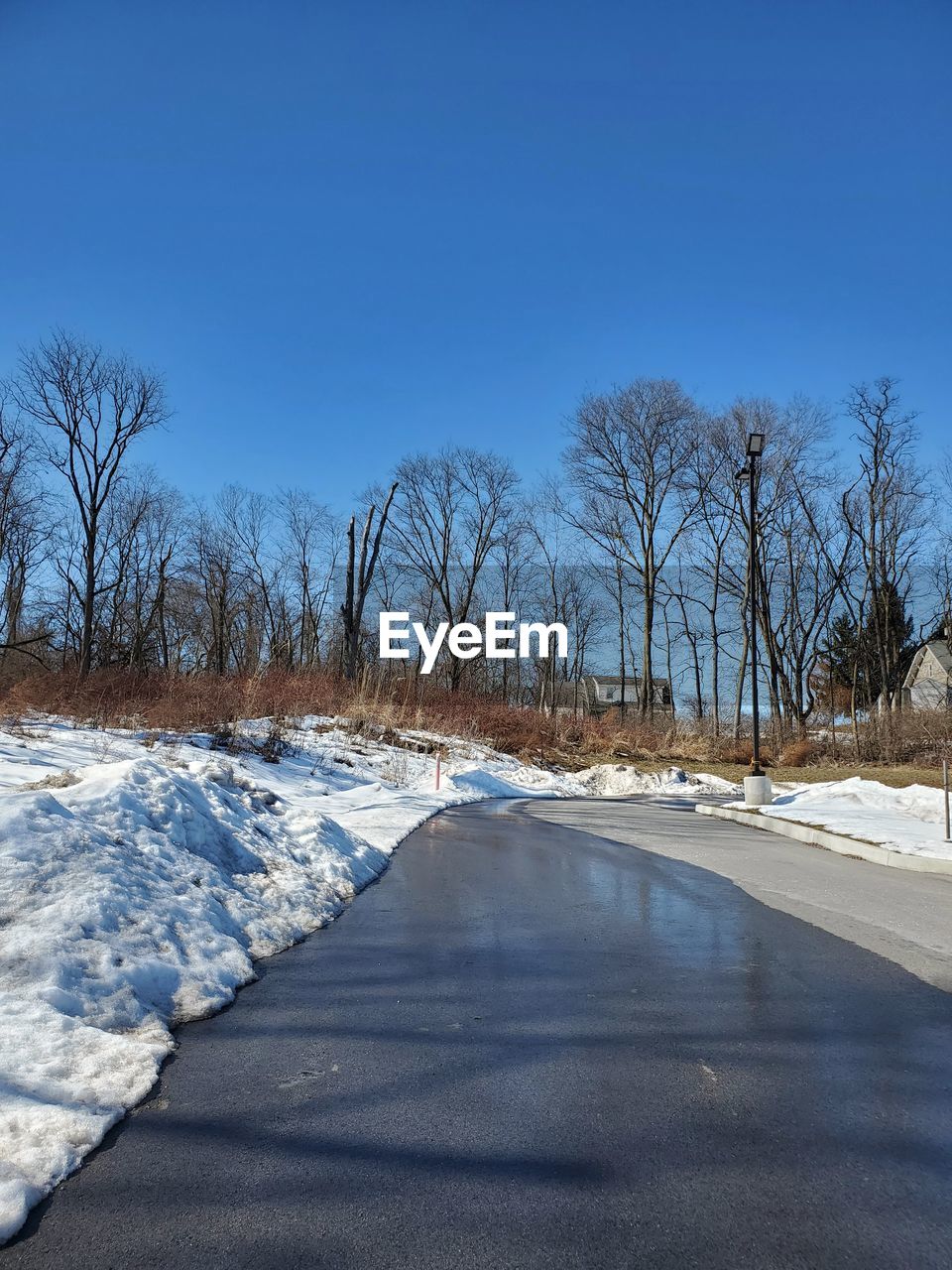 Scenic view of snow covered landscape against clear blue sky