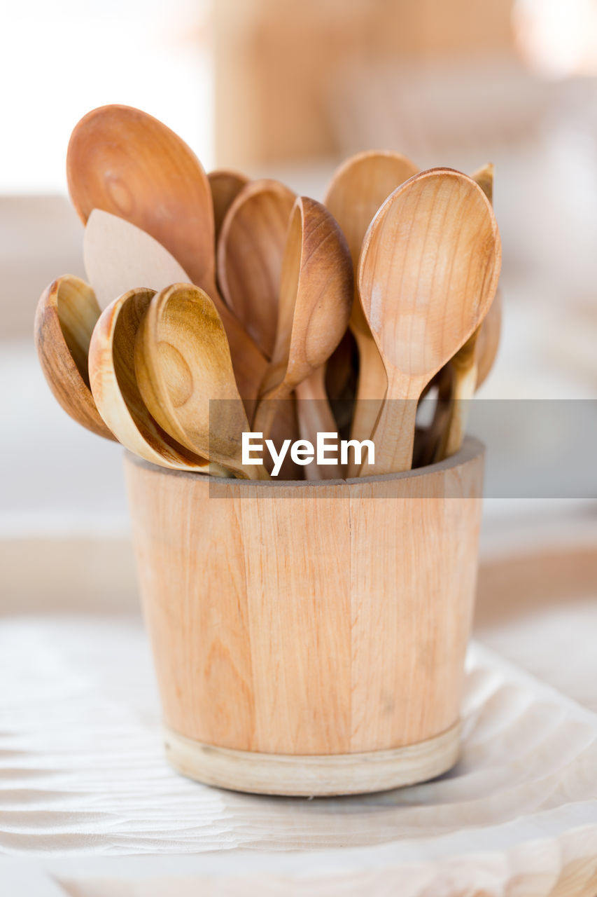 Close-up of wooden spoons in container