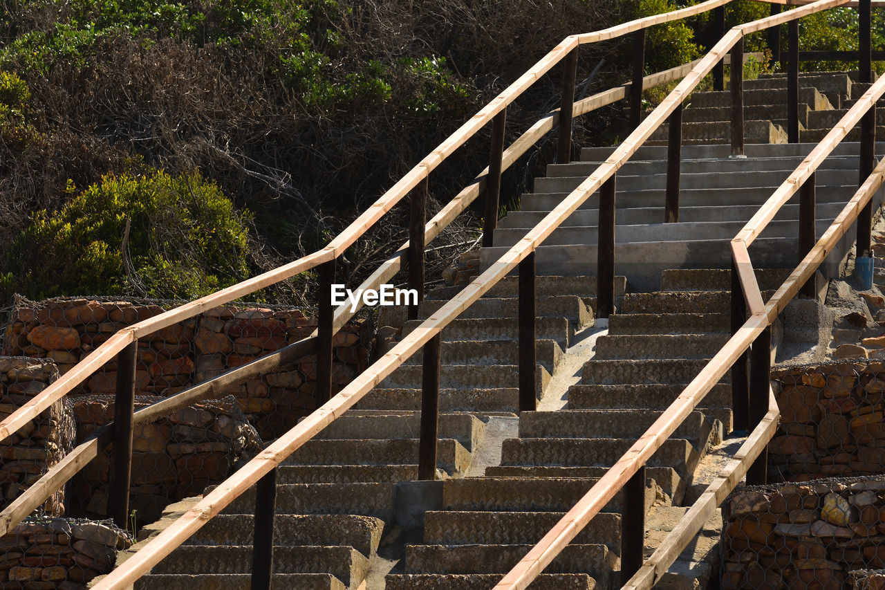 Concrete staircase with handrail going up