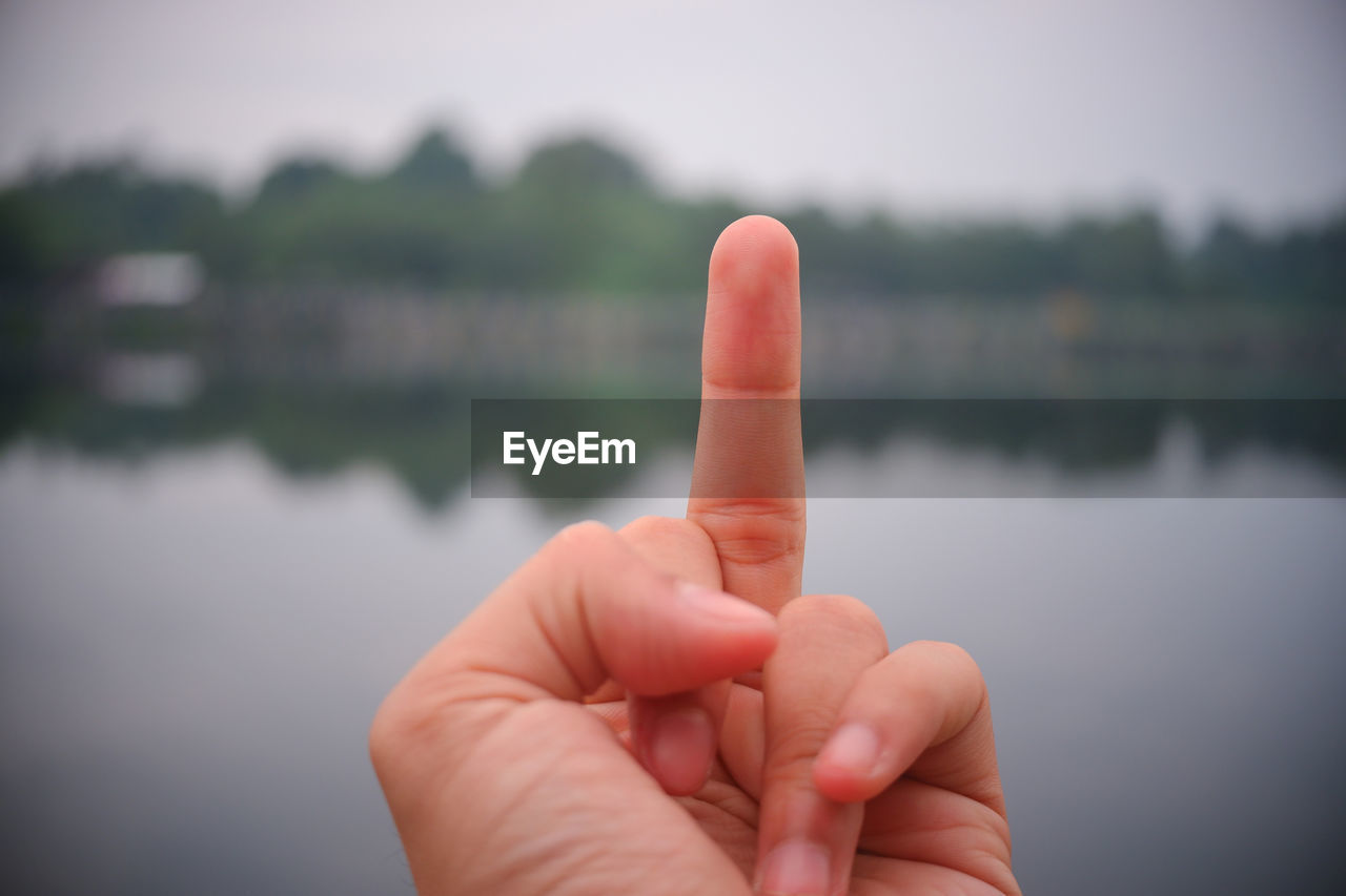CLOSE-UP OF HUMAN HAND ON WATER