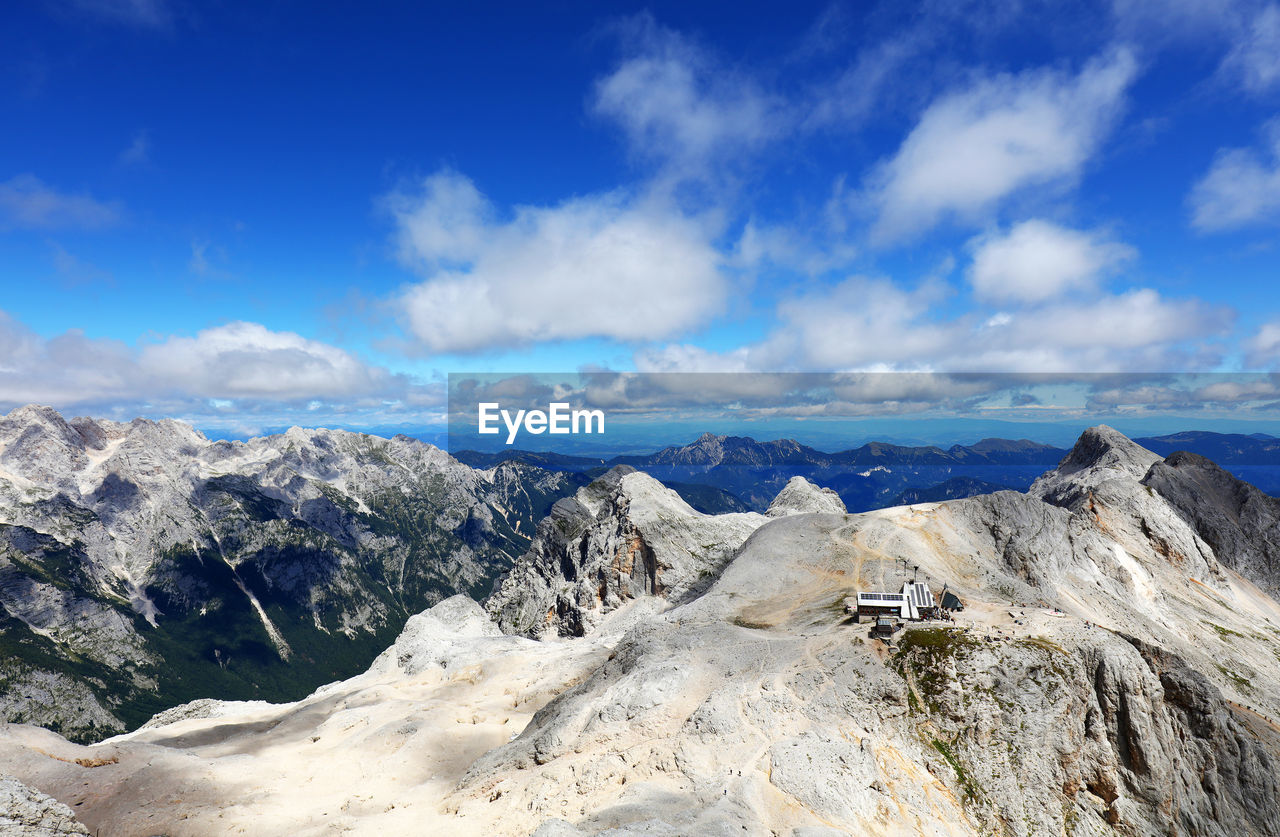 Panoramic view of mountains against blue sky