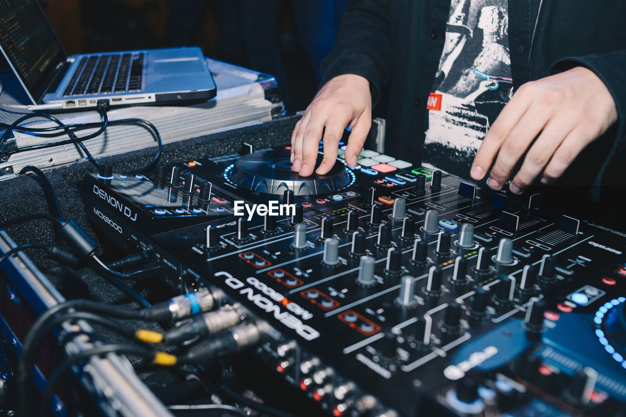 MIDSECTION OF MAN WORKING AT NIGHTCLUB