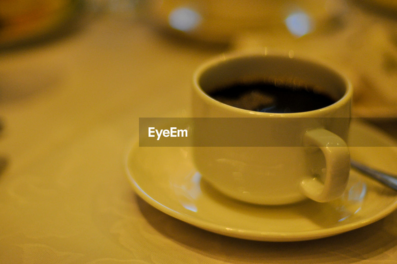 CLOSE-UP OF COFFEE CUP WITH COFFEE CUP